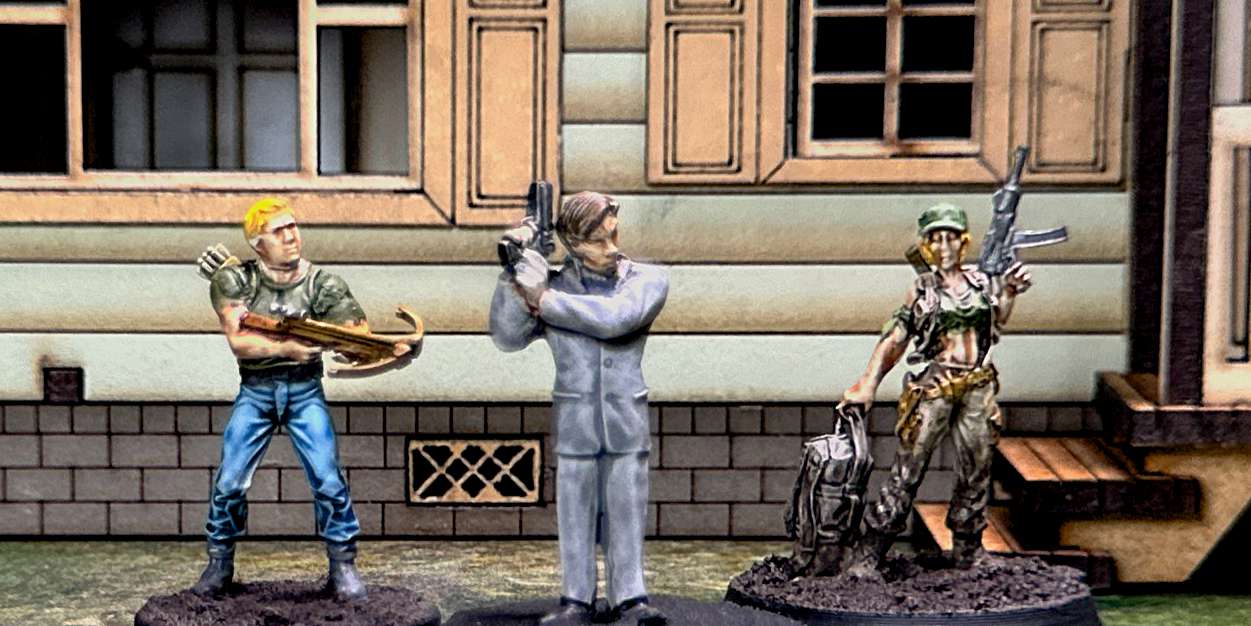 a photo of the miniatures used for the community in the first mission: in the center is a man in a grey business suit carrying a pistol, on the left is a man in a green t-short and blue jeans carrying a crossbow, on the right is a woman wearing military fatigues and carrying a pistol