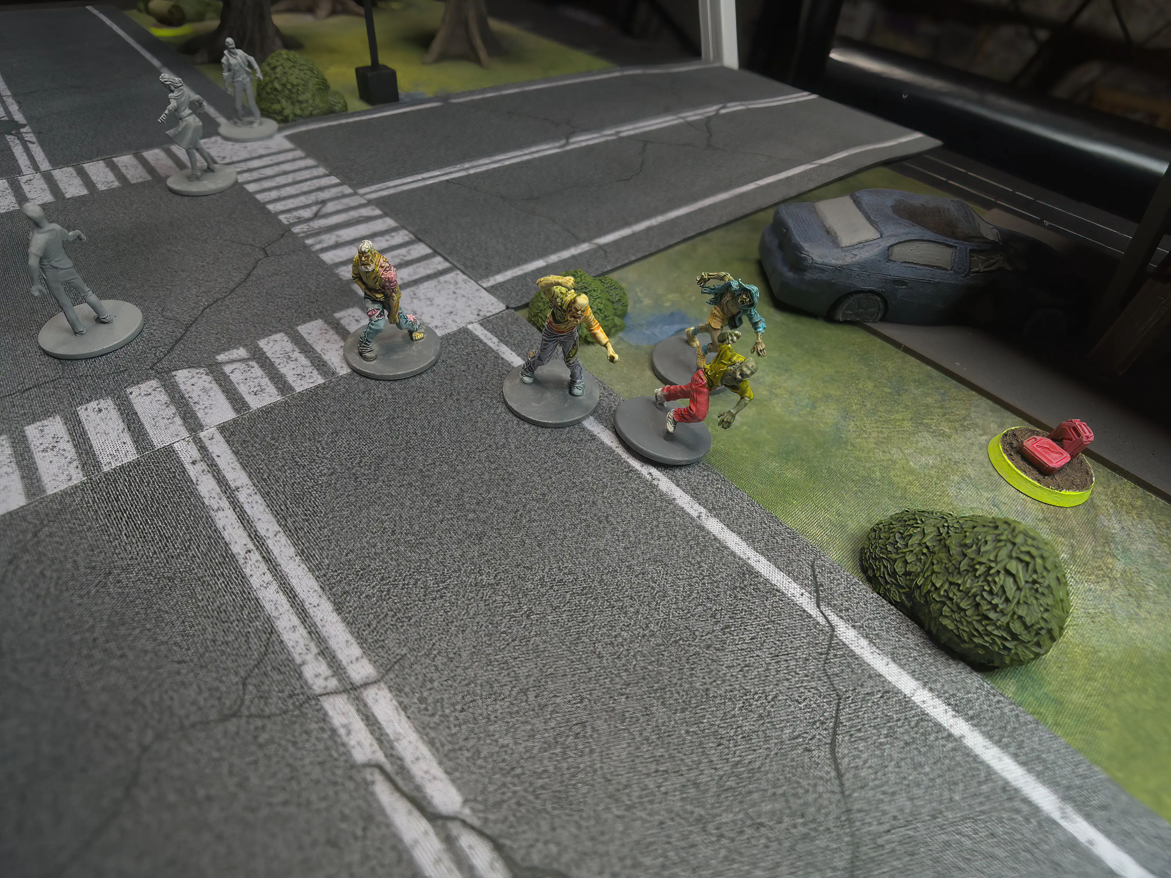photo of four zombie miniatures running out of a gas station