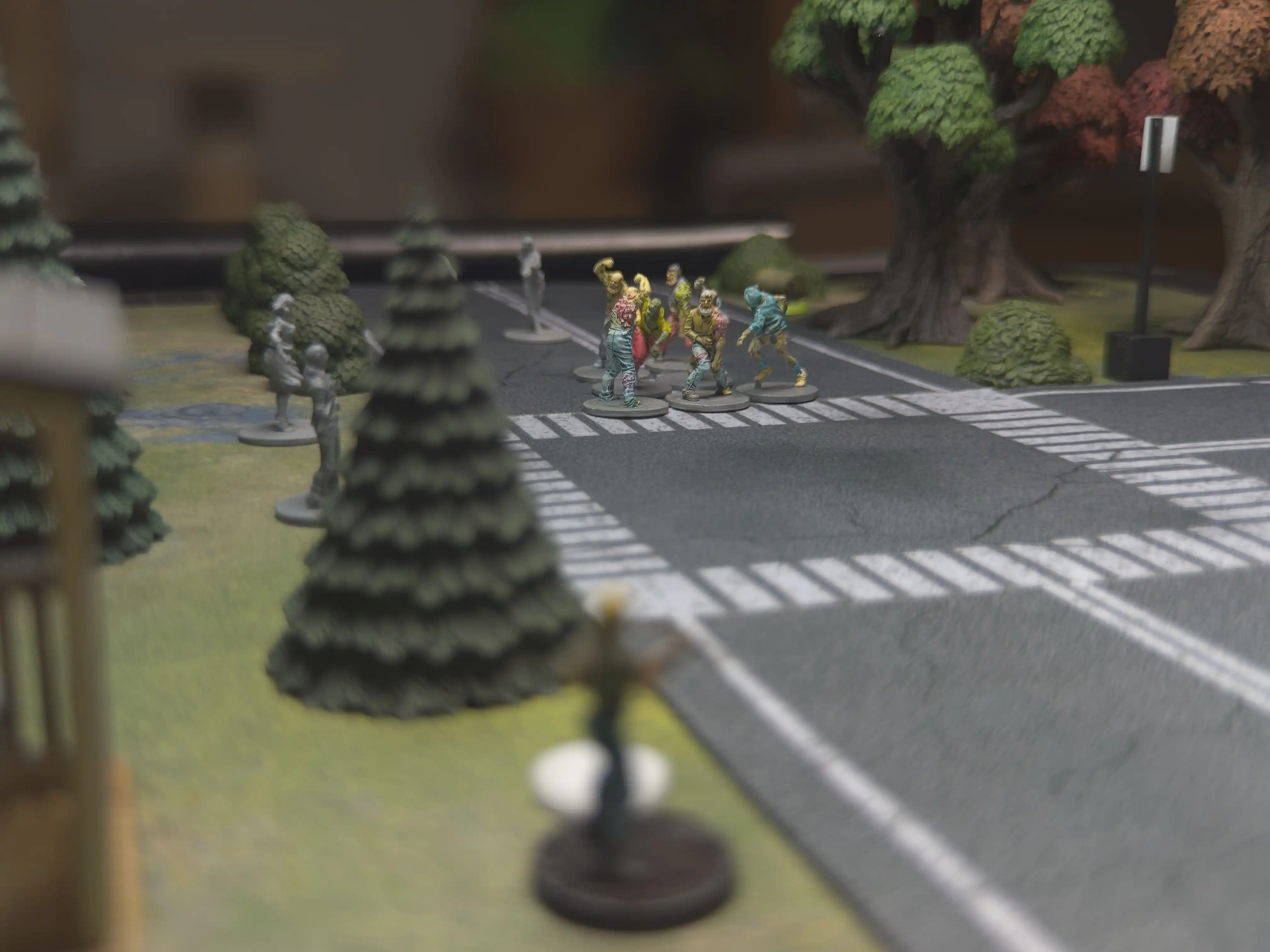 photo taken over-the-shoulder of the narrator's miniature looking toward a horde of zombies half-way across the table